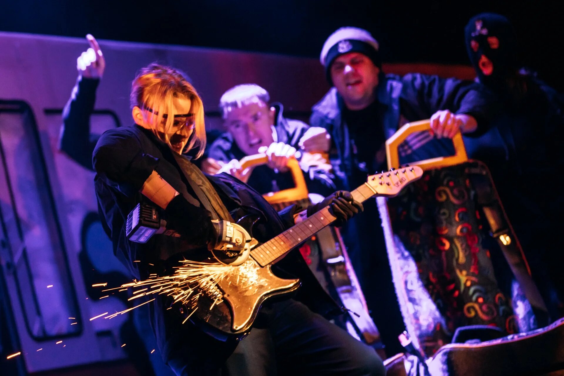 Live music scene in Gerry & Sewell with a guitar throwing sparks across the stage