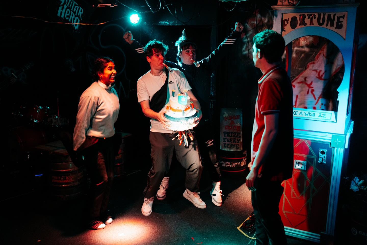The Seagulls and Sad Sad Stories company celebrating with a cake on stage