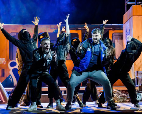 The ensemble of Gerry & Sewell dancing in front of the Metro carriage set
